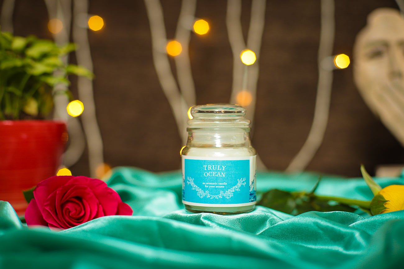 A stylish Aroma Candle in a decorative glass jar, adding elegance to any space