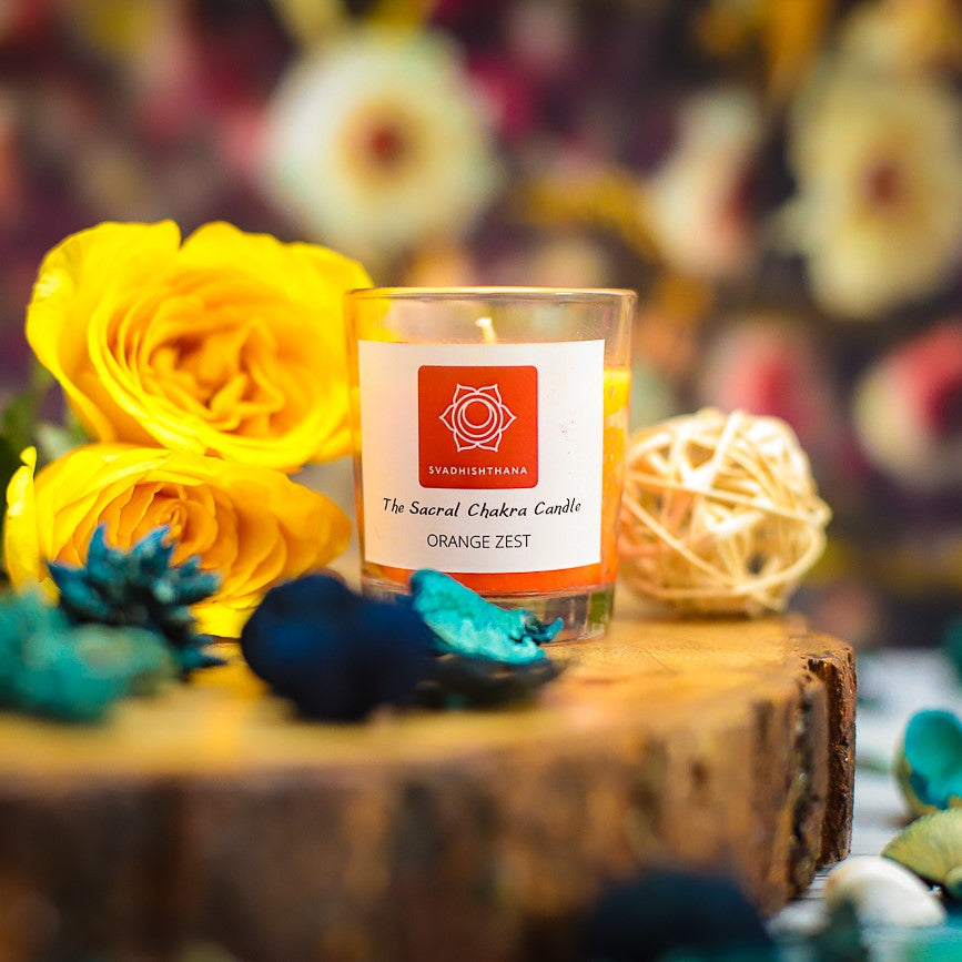 A glowing chakra candle beside yoga props, enhancing spiritual practice