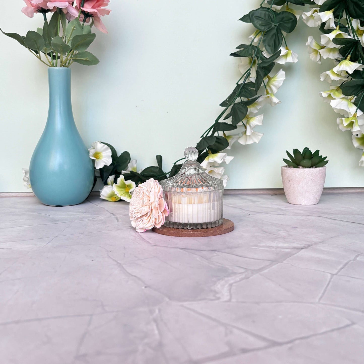 Royal Daisy Candle burning gently in a vintage-inspired glass container