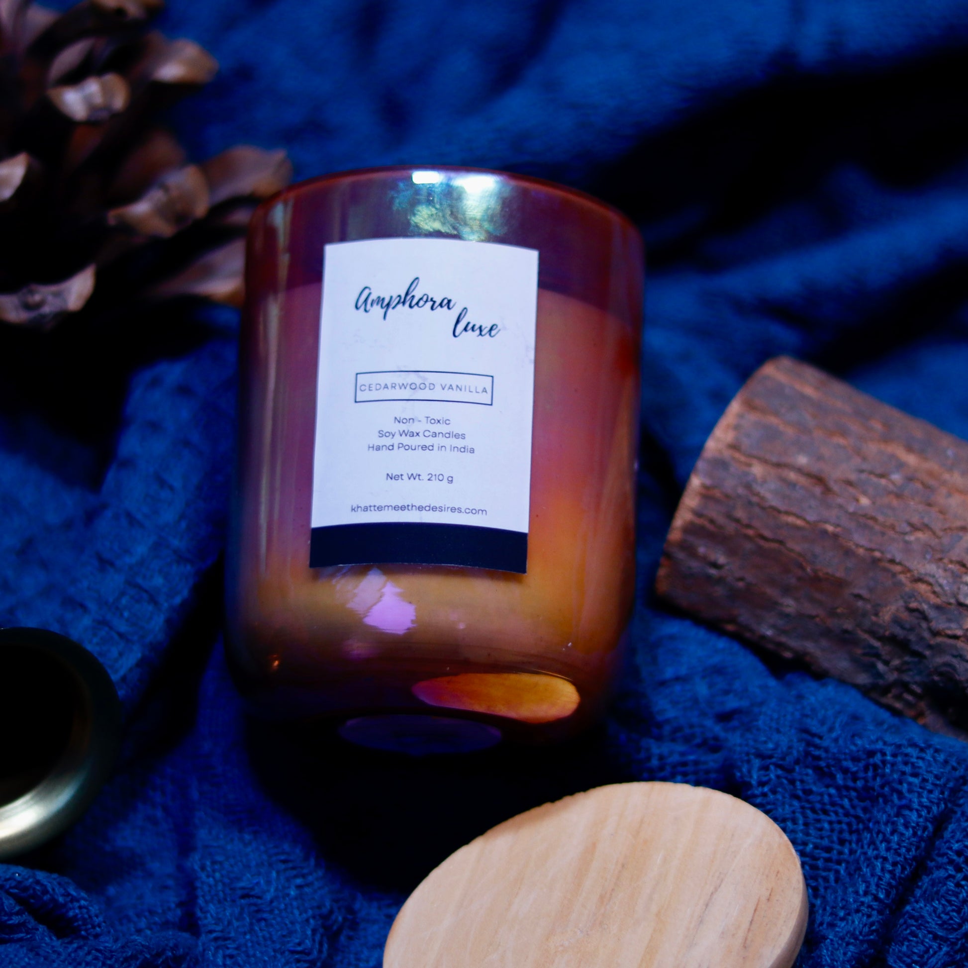 A premium Amphora Luxe Candle releasing a delicate floral fragrance, perfect for self-care moments