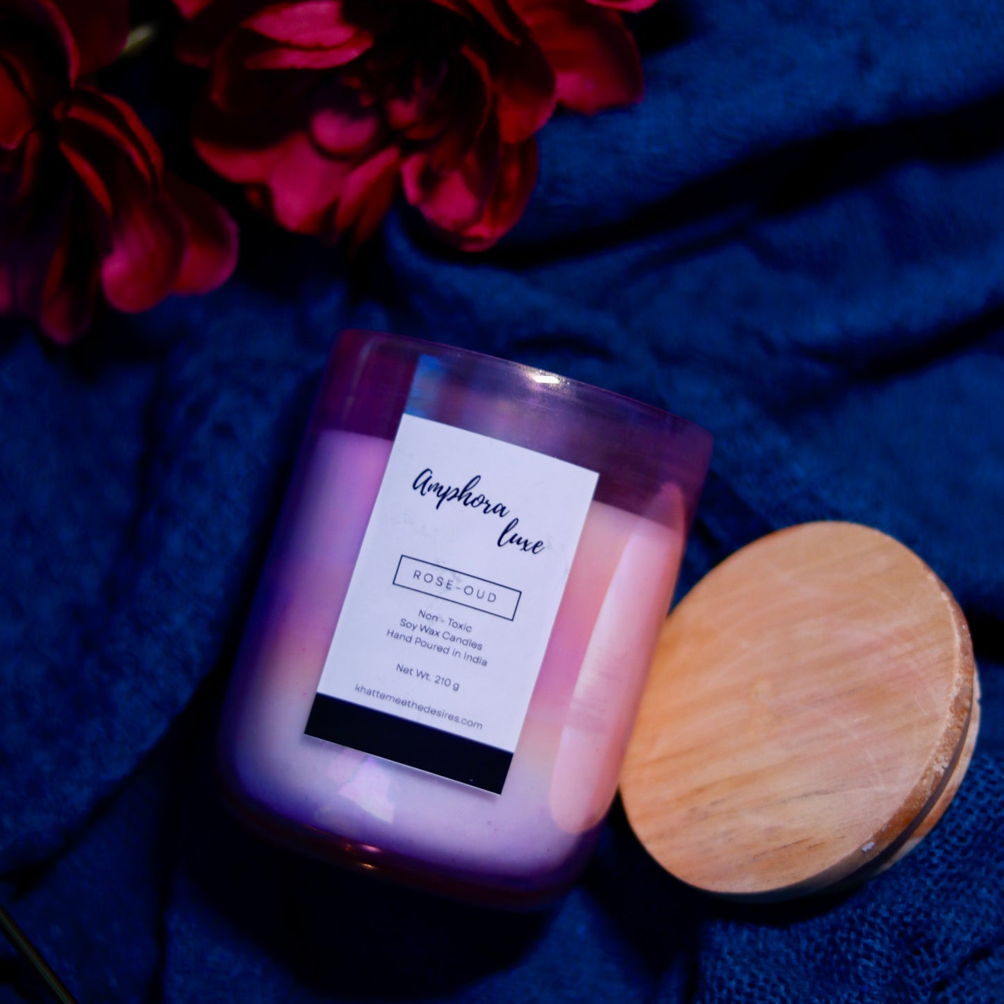 A deep amber Amphora Luxe Candle with a smoky scent, perfect for autumn evenings
