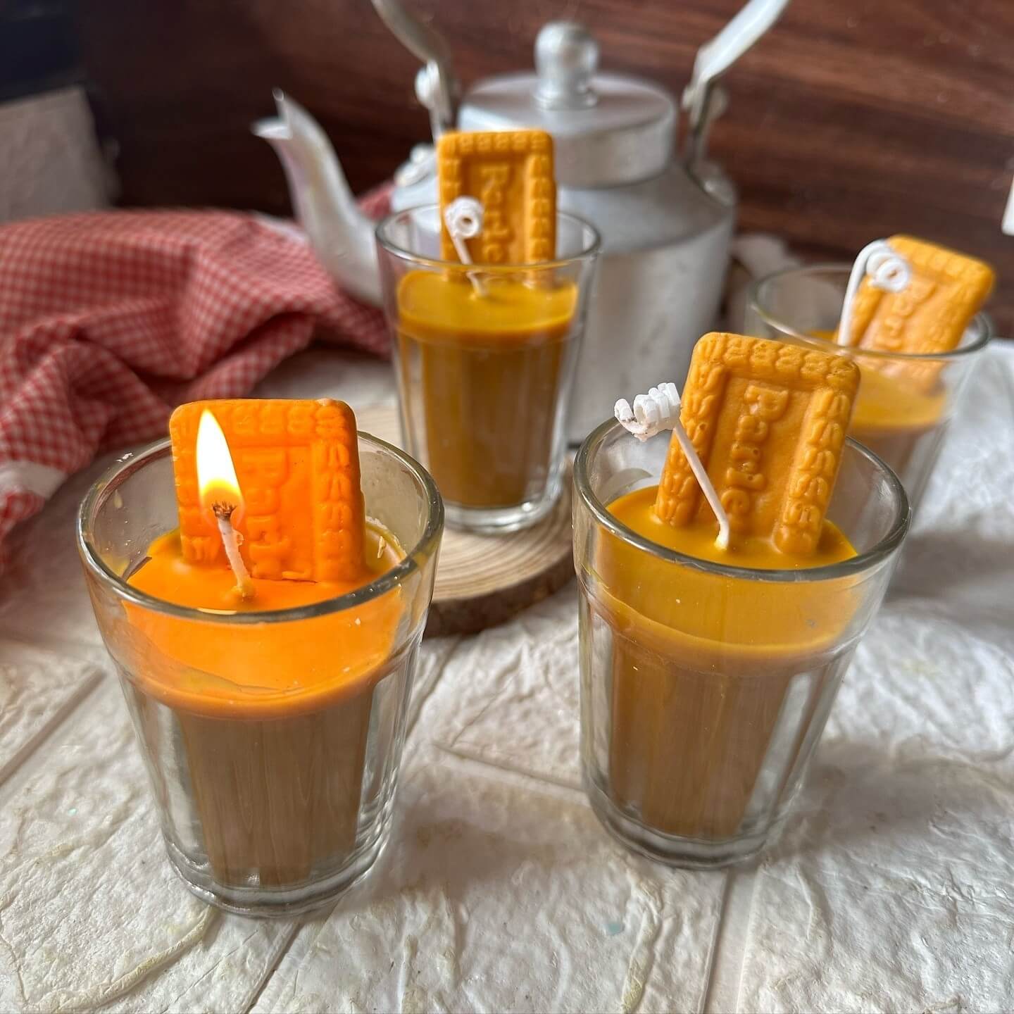 Cozy Chai Biscuit Candle, glowing warmly with the aroma of spiced tea and baked biscuits