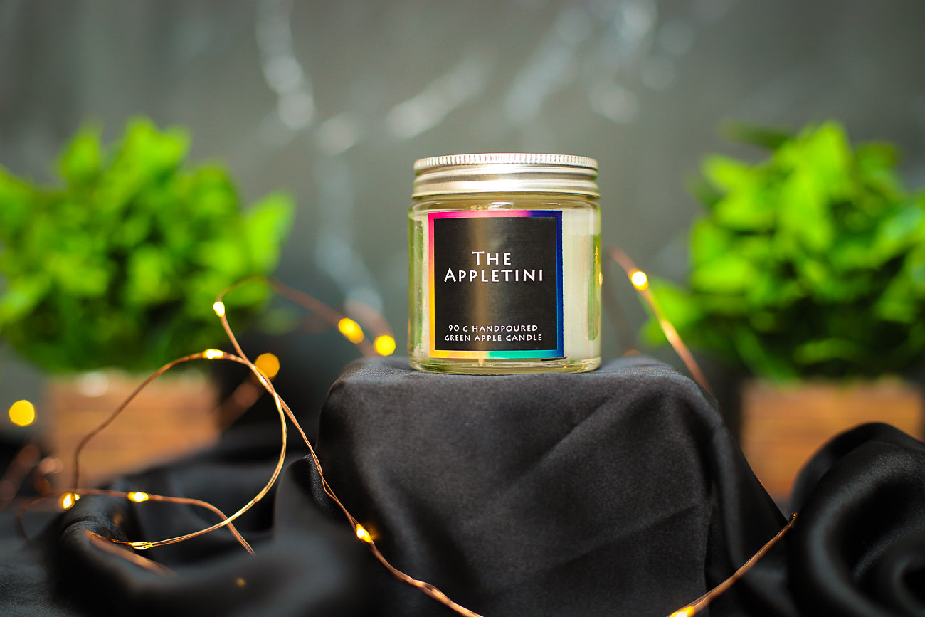 A luxurious Serene Candle, casting a warm glow in a tranquil setting
