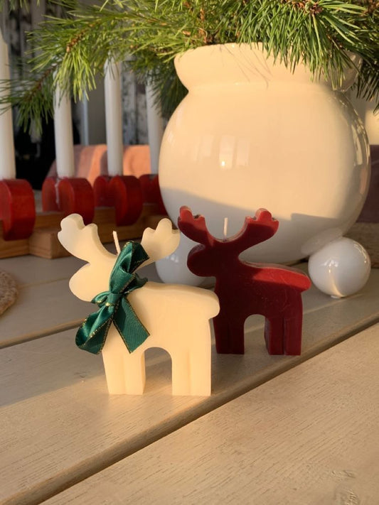 Reindeer-shaped candle with elegant antlers, glowing softly